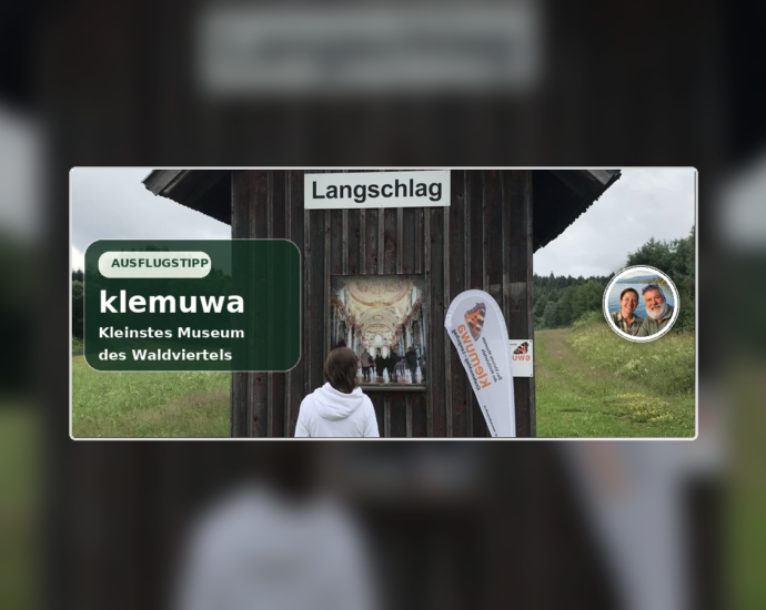 Klemuwa in Langschlag, featuring the former railroad guardhouse, the "Langschlag" sign, and the Anna-and-Herbert badge